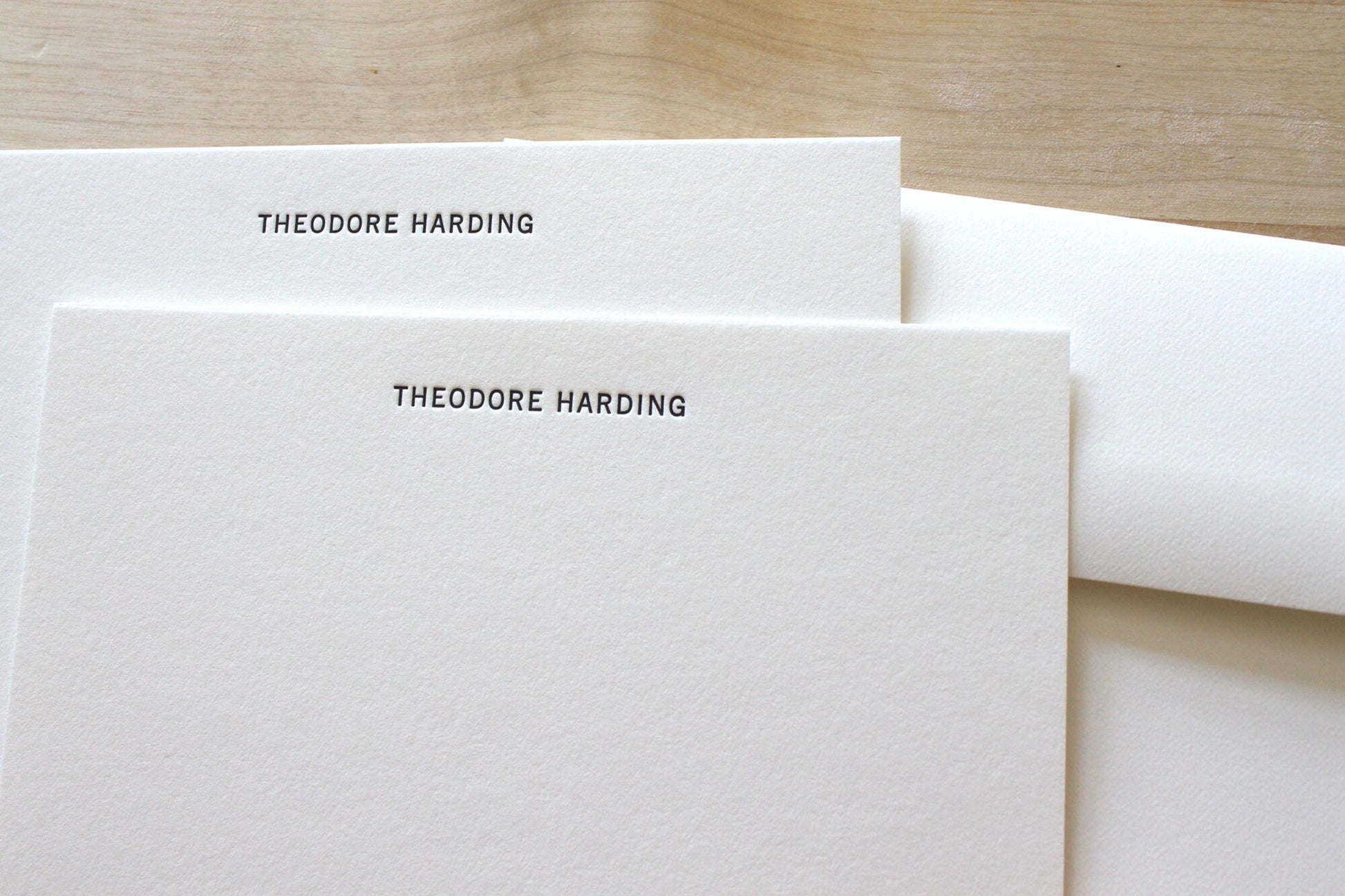 Flat lay of complete modern letterpress stationery set, including notecards and envelopes